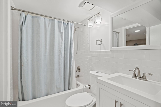 full bathroom with vanity, backsplash, tile walls, toilet, and shower / bath combo