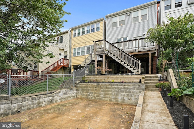 back of house featuring a wooden deck