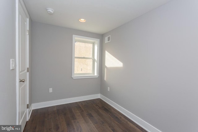 spare room with dark hardwood / wood-style flooring