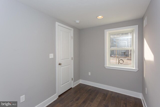 unfurnished room with recessed lighting, dark wood-style flooring, visible vents, and baseboards