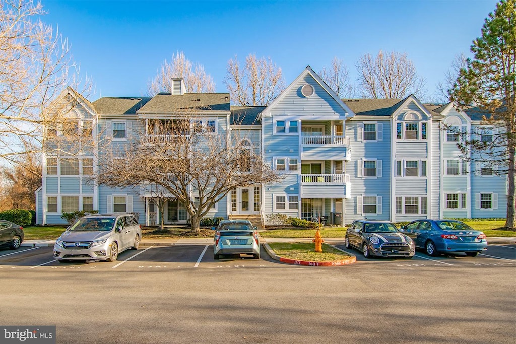 view of property featuring uncovered parking