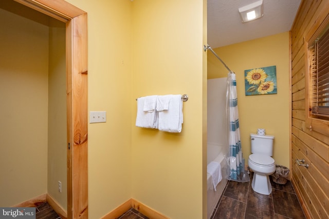 bathroom featuring toilet, shower / bath combination with curtain, hardwood / wood-style floors, and a textured ceiling