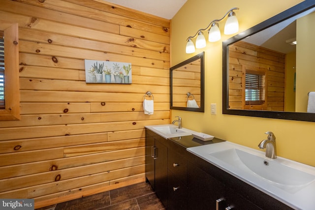 bathroom with tile patterned floors, wood walls, and vanity