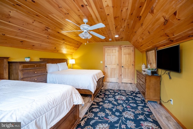 bedroom featuring lofted ceiling, light hardwood / wood-style flooring, and ceiling fan