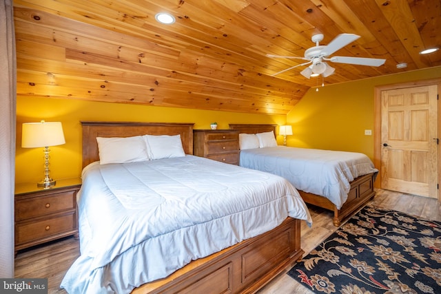 bedroom featuring wood ceiling, vaulted ceiling, ceiling fan, and light hardwood / wood-style floors