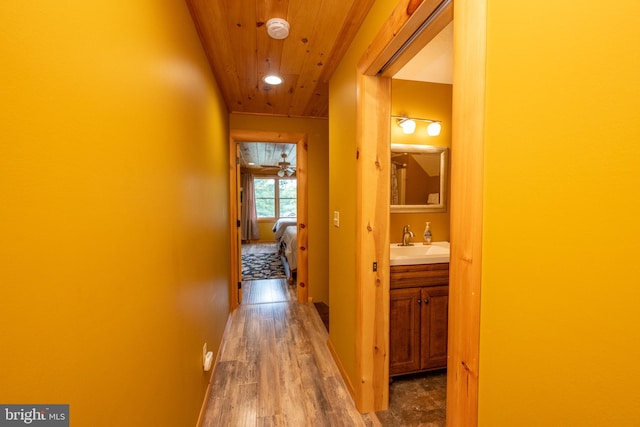 hall with sink, wooden ceiling, and dark hardwood / wood-style flooring