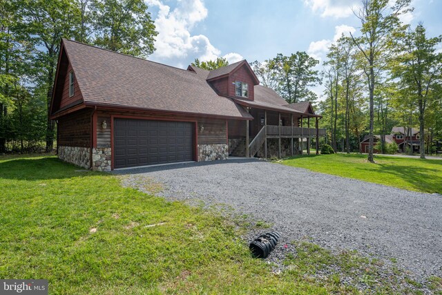 view of front of home with a front lawn and a garage