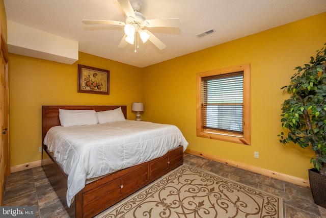 bedroom featuring a ceiling fan, visible vents, and baseboards