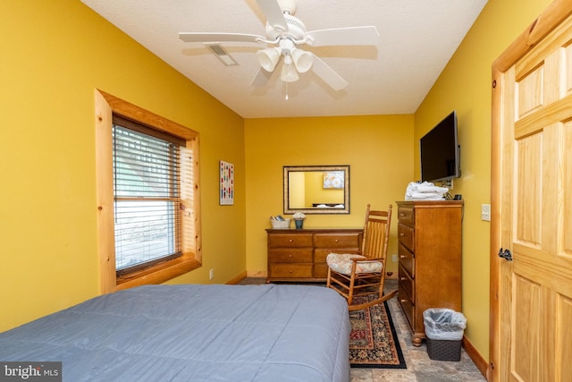 bedroom with a textured ceiling and ceiling fan