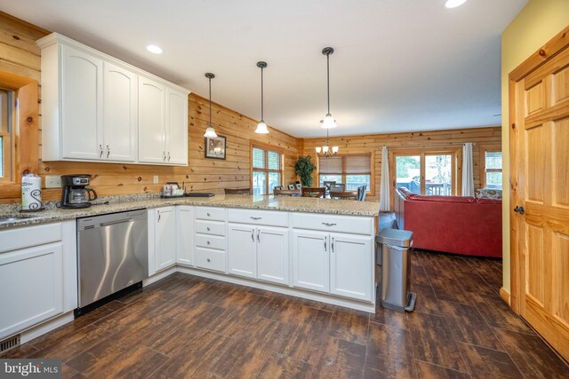 kitchen featuring white cabinets, dishwasher, wooden walls, decorative light fixtures, and dark hardwood / wood-style floors