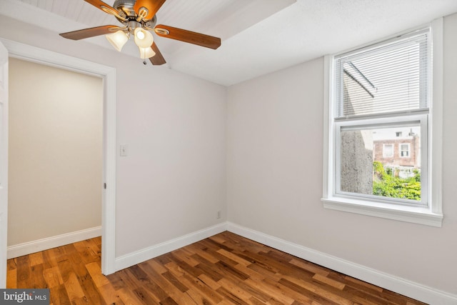 empty room with ceiling fan, lofted ceiling, and hardwood / wood-style floors