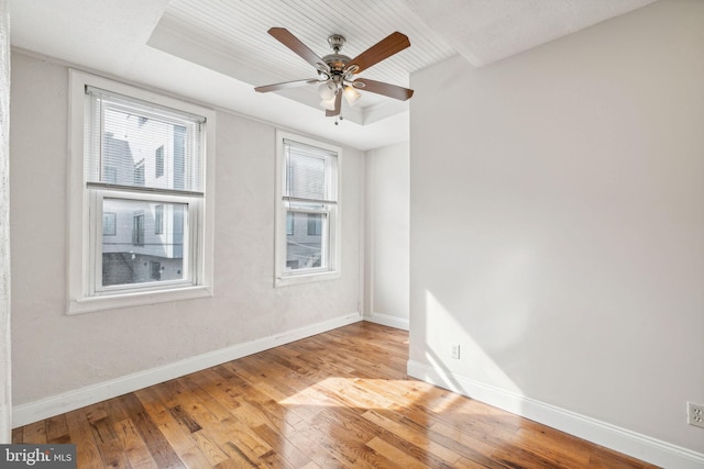 unfurnished room featuring light wood-type flooring, ceiling fan, and plenty of natural light