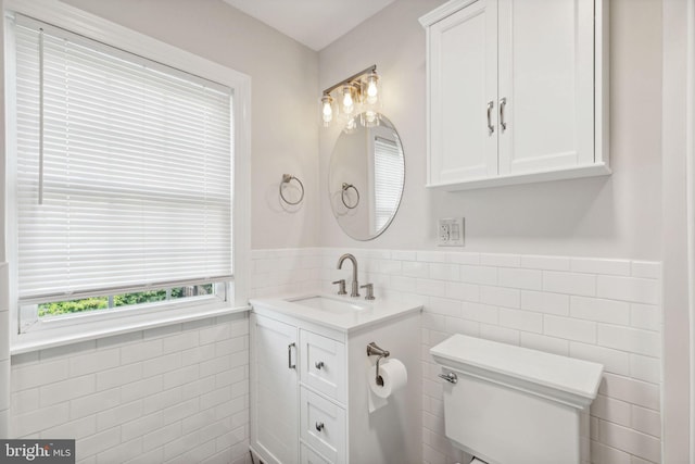 bathroom featuring tile walls, vanity, and toilet