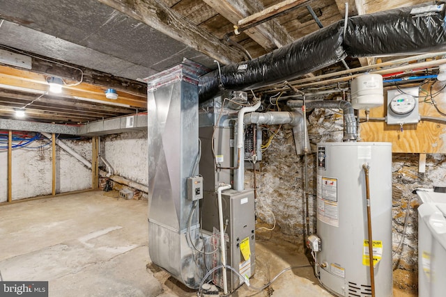 utility room featuring washer / clothes dryer, gas water heater, and heating unit