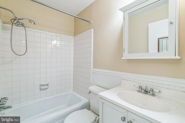 full bathroom featuring a wainscoted wall, shower / washtub combination, vanity, and toilet