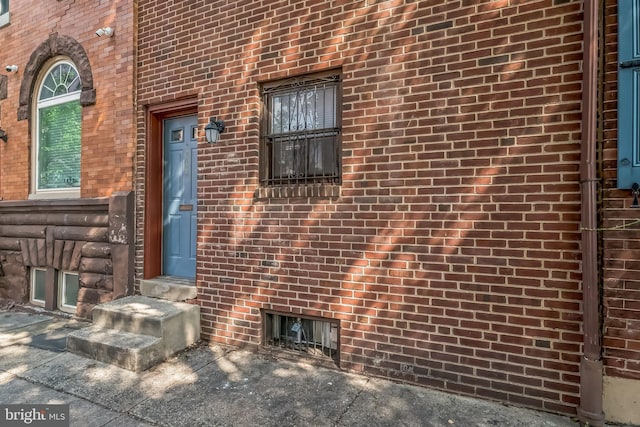 entrance to property with brick siding