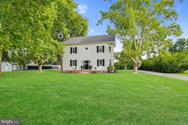 rear view of house with a lawn