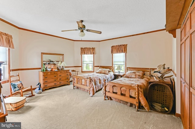 bedroom featuring light carpet, crown molding, a textured ceiling, ceiling fan, and a closet