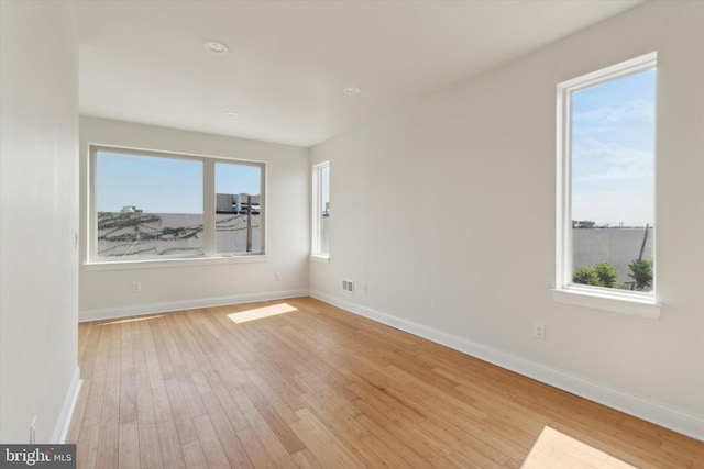 empty room with light hardwood / wood-style flooring