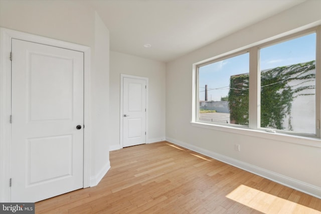 empty room with light hardwood / wood-style floors