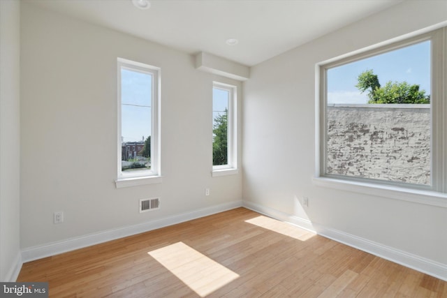 unfurnished room with light hardwood / wood-style floors