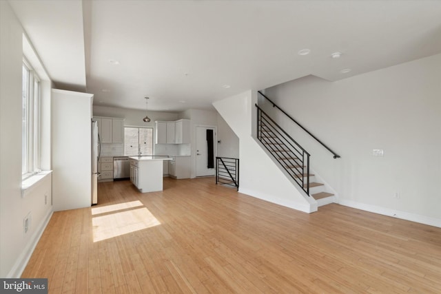 unfurnished living room featuring light hardwood / wood-style floors