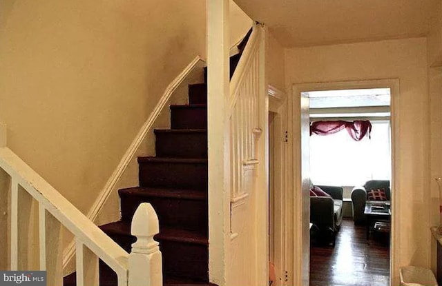 stairs featuring hardwood / wood-style floors