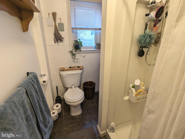 bathroom featuring toilet and tile patterned floors