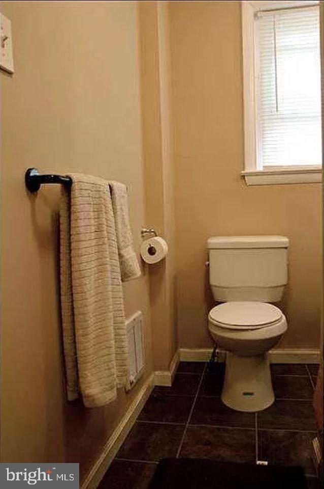 bathroom with tile patterned flooring and toilet