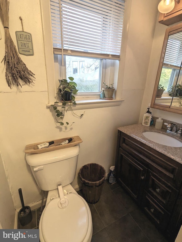 bathroom featuring vanity, toilet, and tile patterned flooring