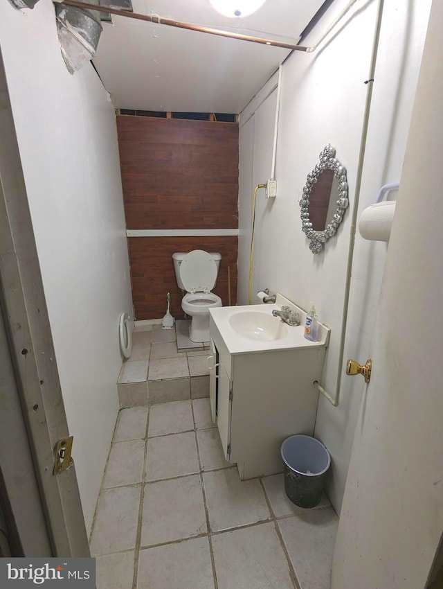 bathroom featuring tile patterned flooring, toilet, and vanity