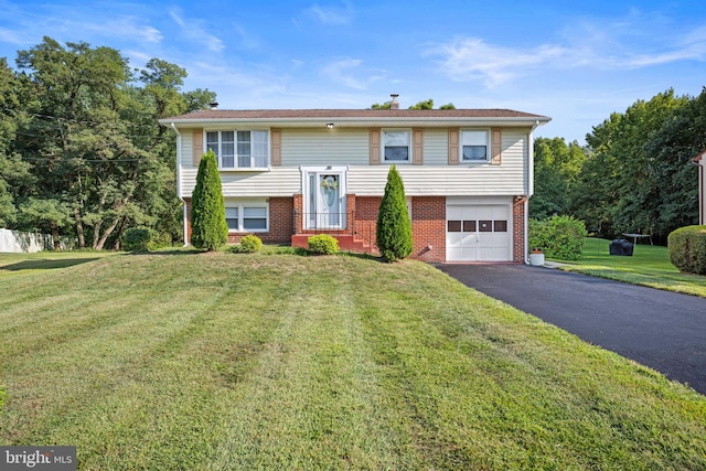 bi-level home with a front yard and a garage