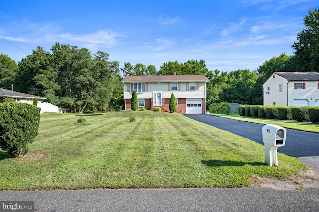 split foyer home with a front lawn and a garage