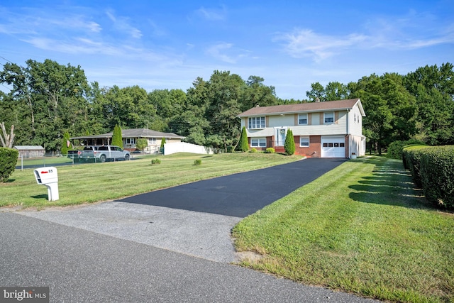 bi-level home featuring a front lawn and a garage