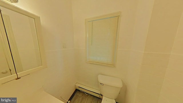 bathroom featuring baseboard heating and toilet