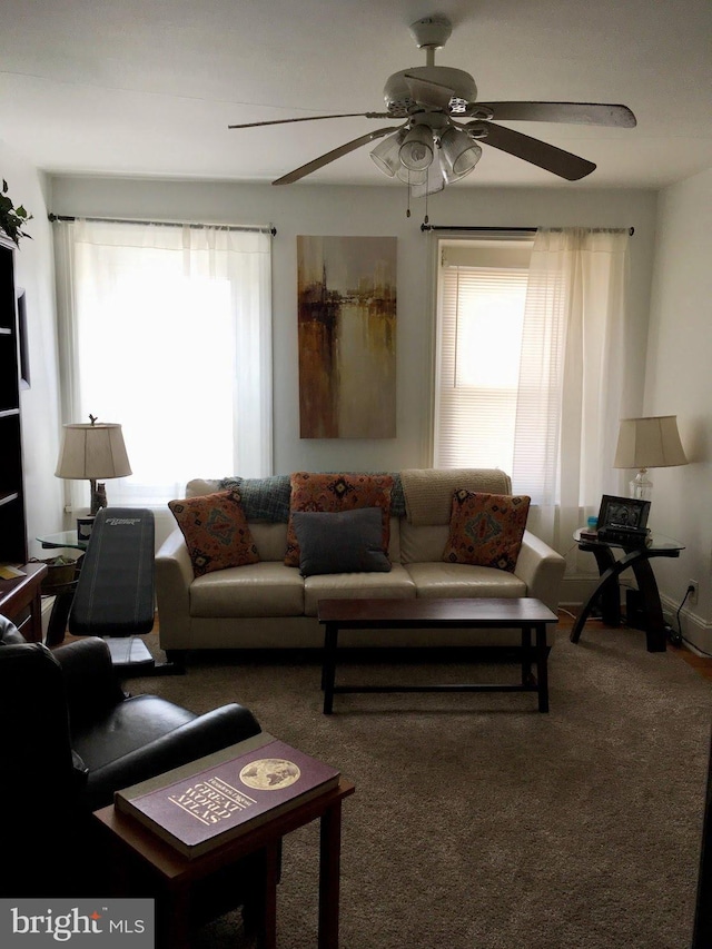 living room with ceiling fan and carpet floors