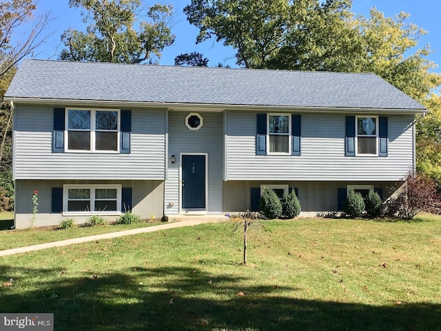 raised ranch featuring a front lawn