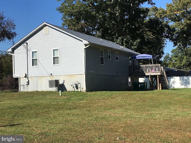 back of house featuring a yard and a wooden deck