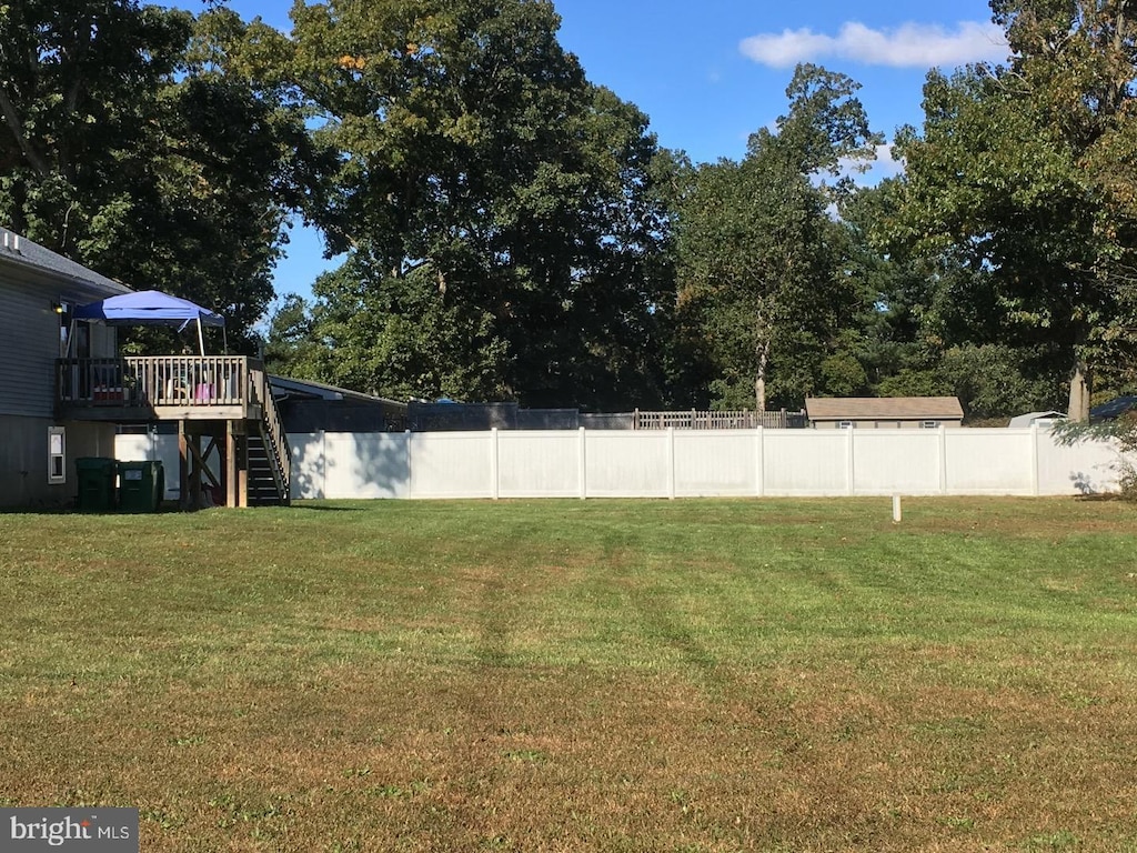 view of yard with a wooden deck