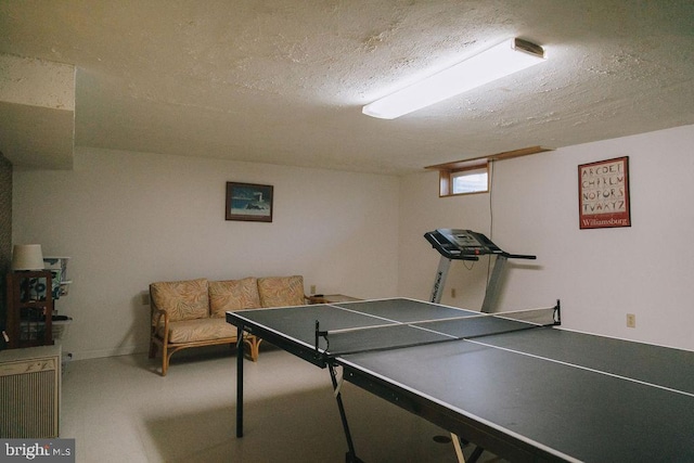 game room with a textured ceiling