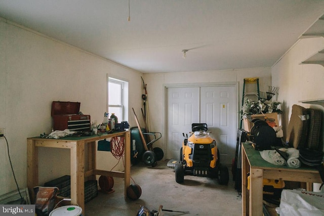 misc room featuring a workshop area and concrete floors