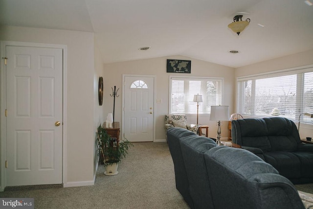 carpeted living room featuring vaulted ceiling