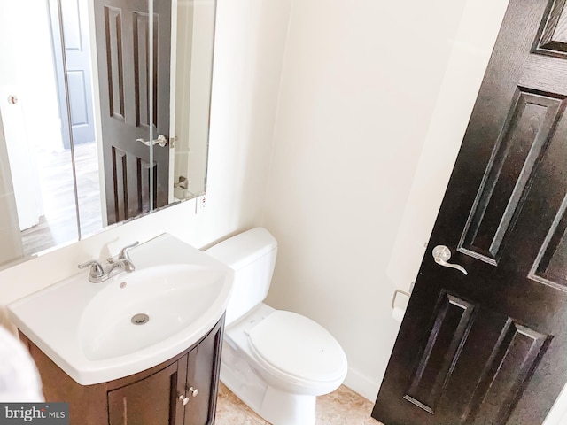 bathroom with vanity, toilet, and tile patterned floors