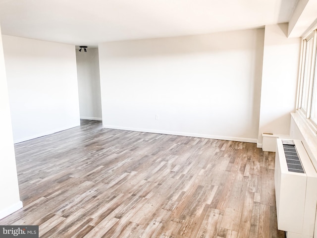 spare room featuring light hardwood / wood-style floors and radiator