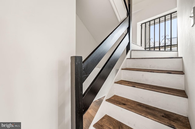 staircase featuring wood-type flooring