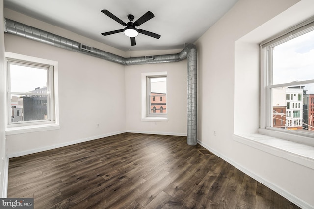 empty room with ceiling fan and a healthy amount of sunlight