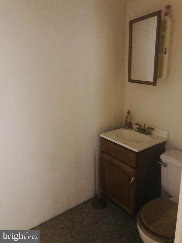 bathroom featuring vanity and toilet