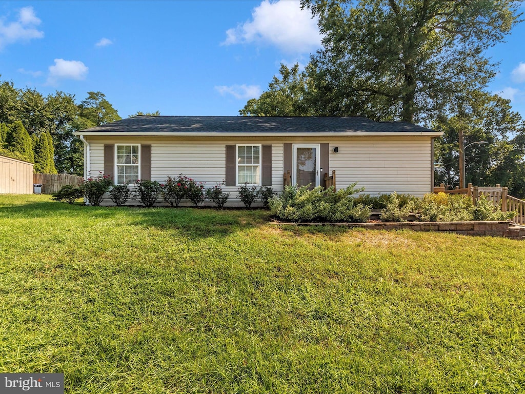 single story home with fence and a front yard