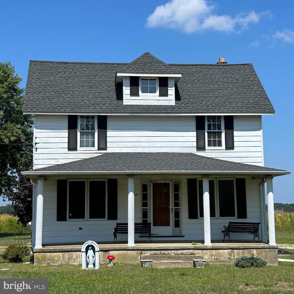 view of front facade featuring covered porch and roof with shingles