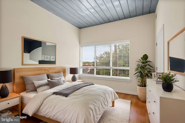 bedroom with wooden ceiling and wood finished floors